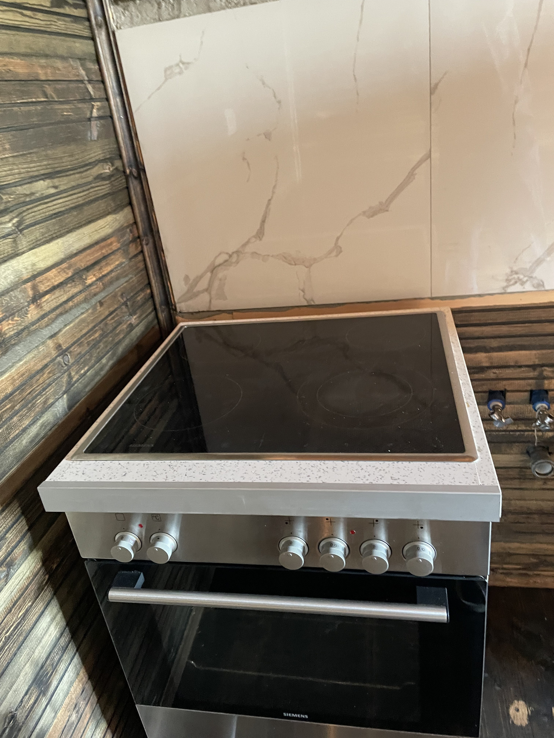 Electric stove with oven marble backsplash