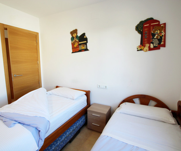 Twin beds with playful wall art