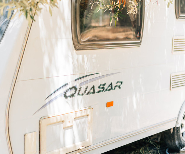Caravan exterior under olive tree