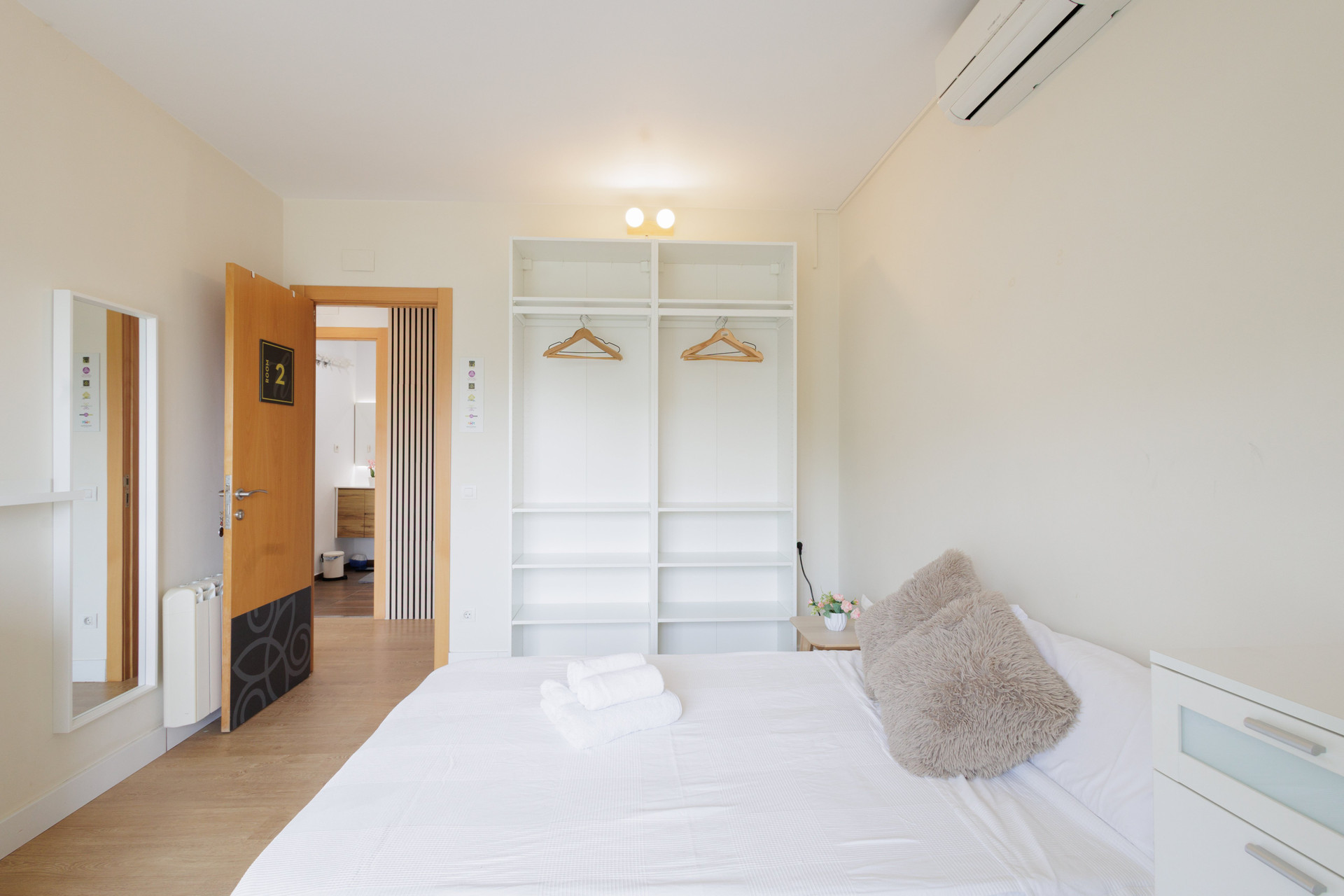 Bright bedroom with open wardrobe