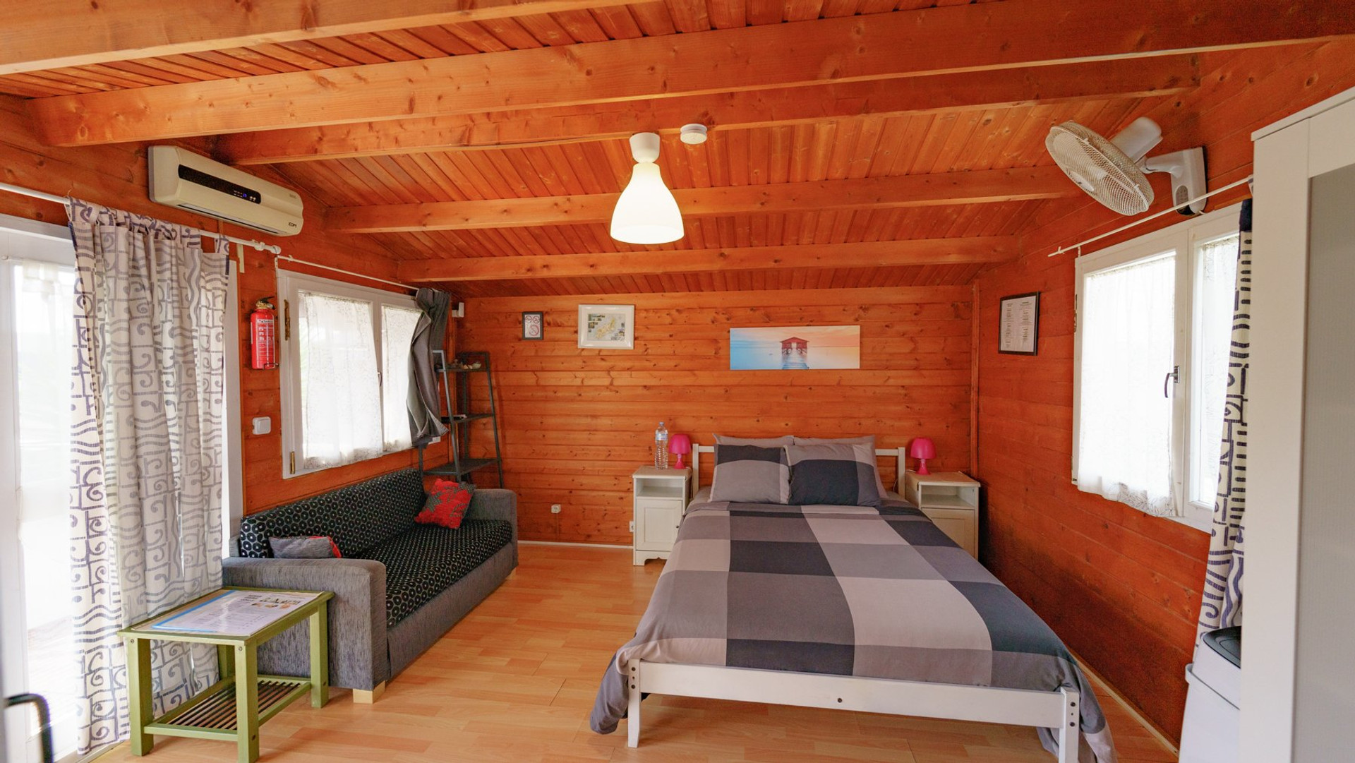 Wooden cabin bedroom with sofa
