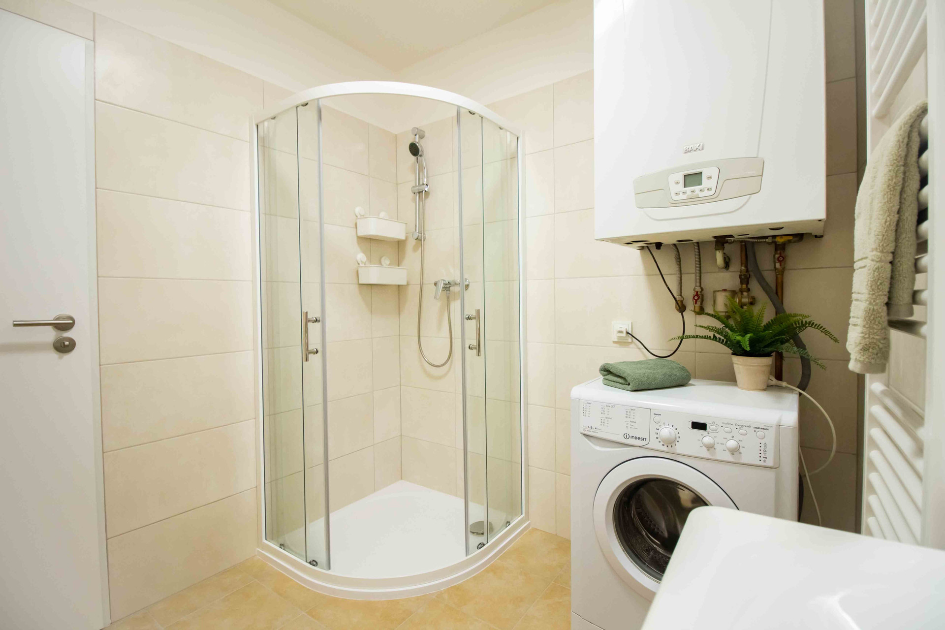 Bathroom with shower and washing machine