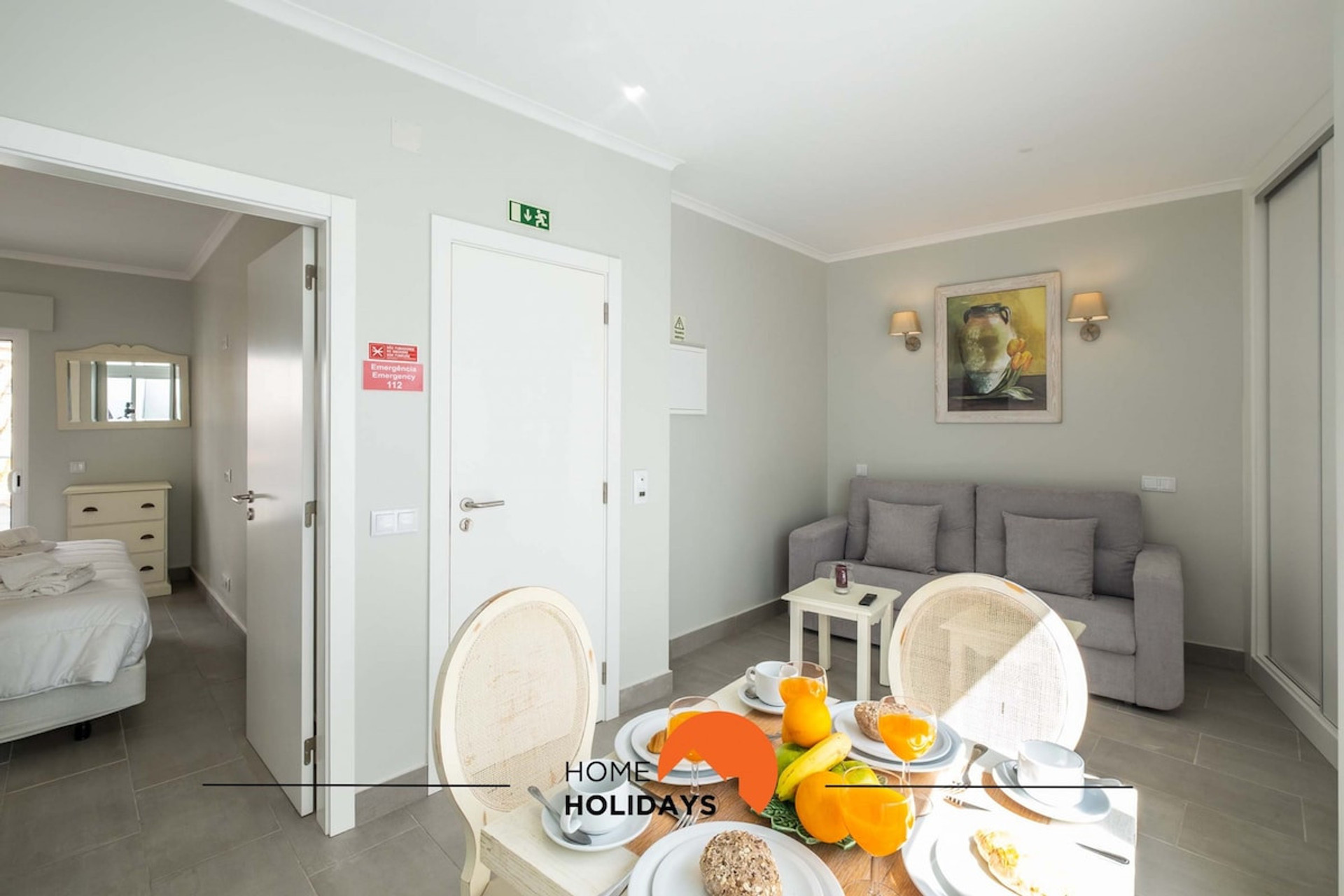 The living room is open, containing a dining area,