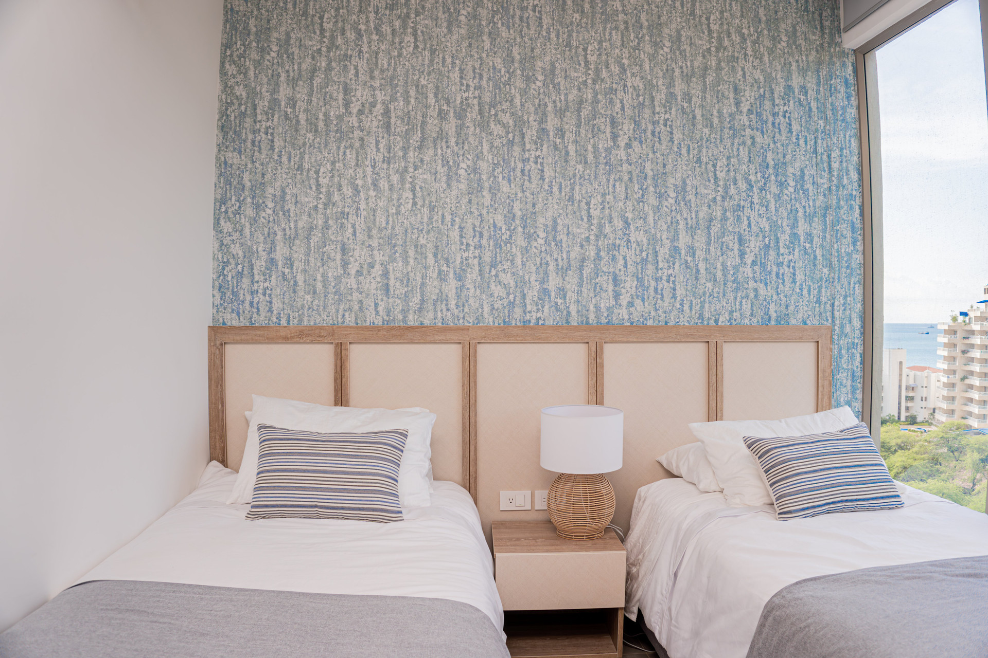 Twin beds with blue accent wall