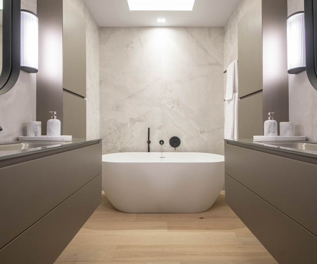 Bathroom with tub and vanities