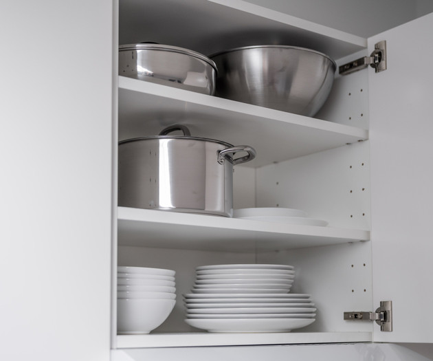 Kitchen cabinet with dishes and pots