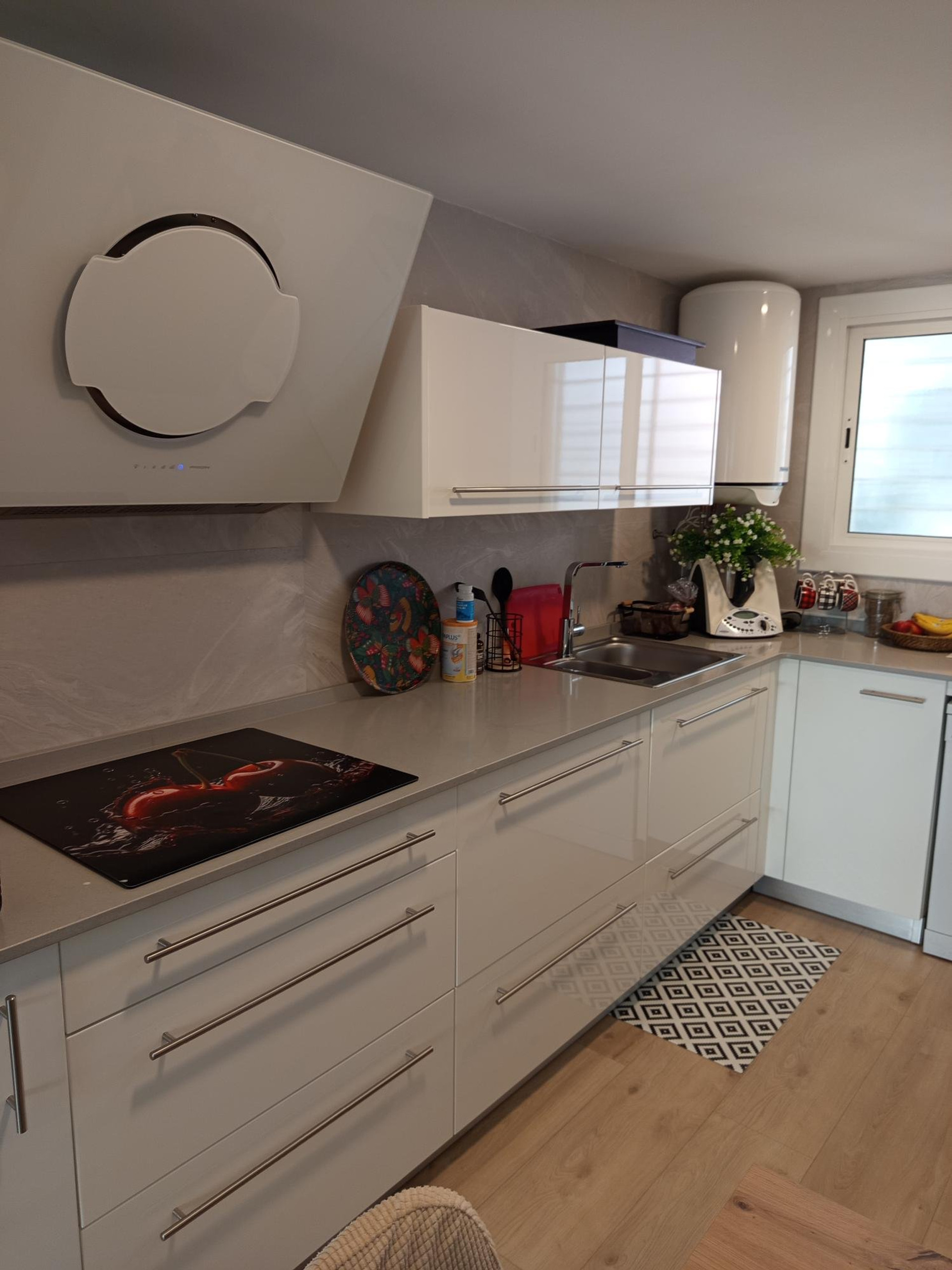 Modern white kitchen with induction hob
