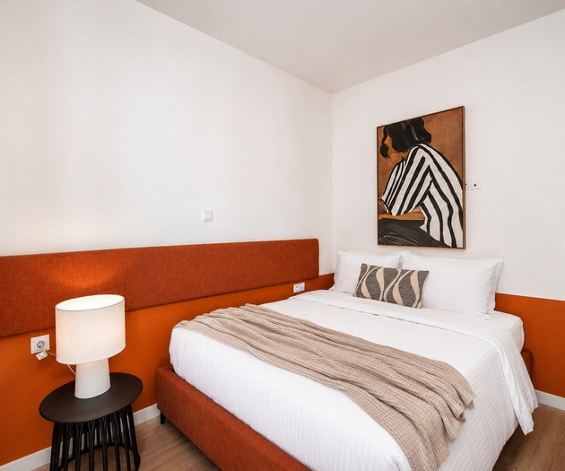 Bedroom with orange headboard