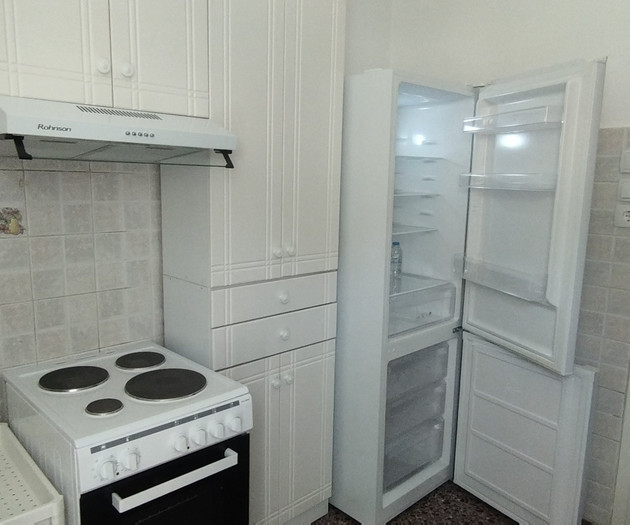 Kitchen with open fridge