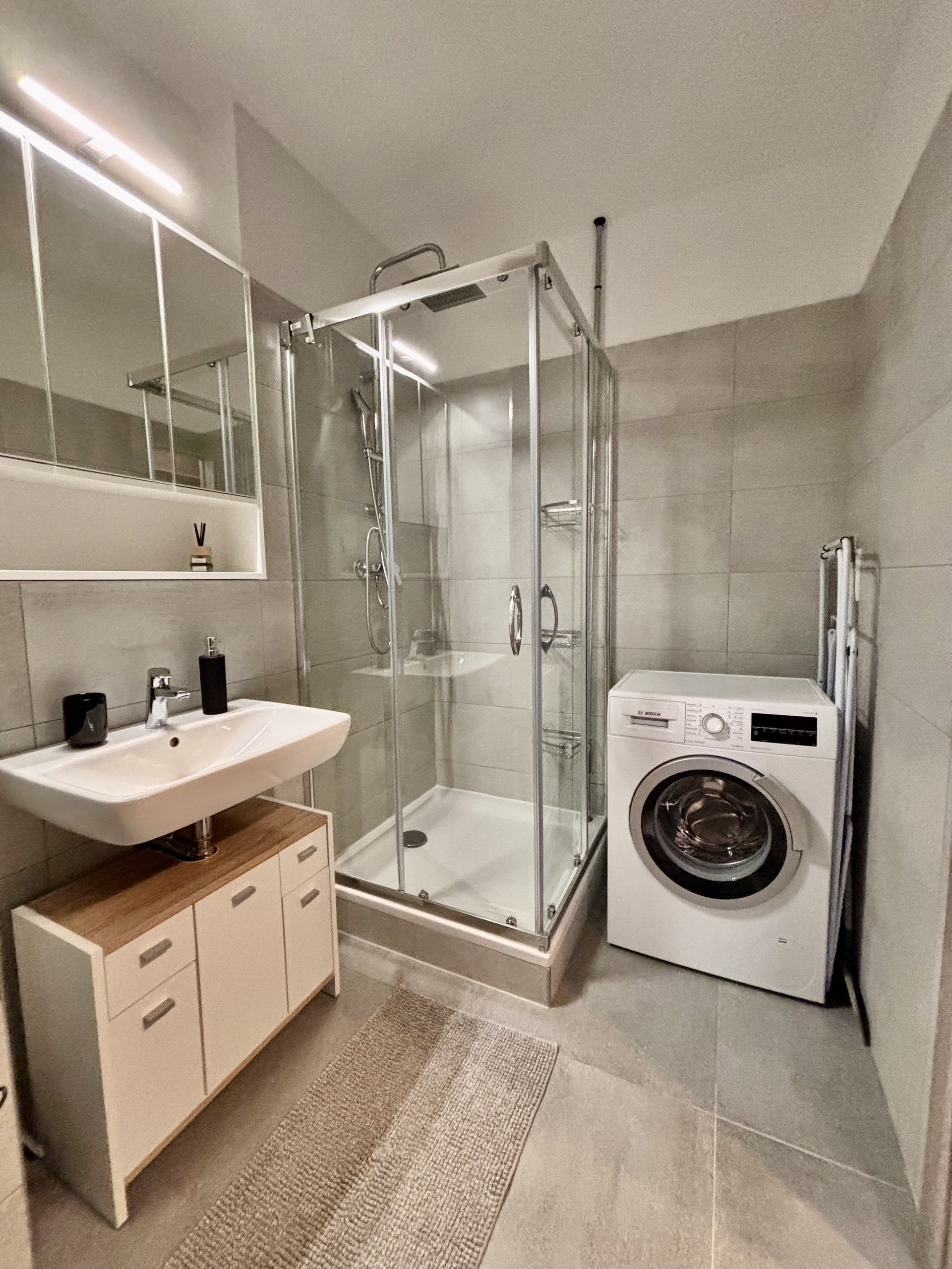 Bathroom with shower and washer