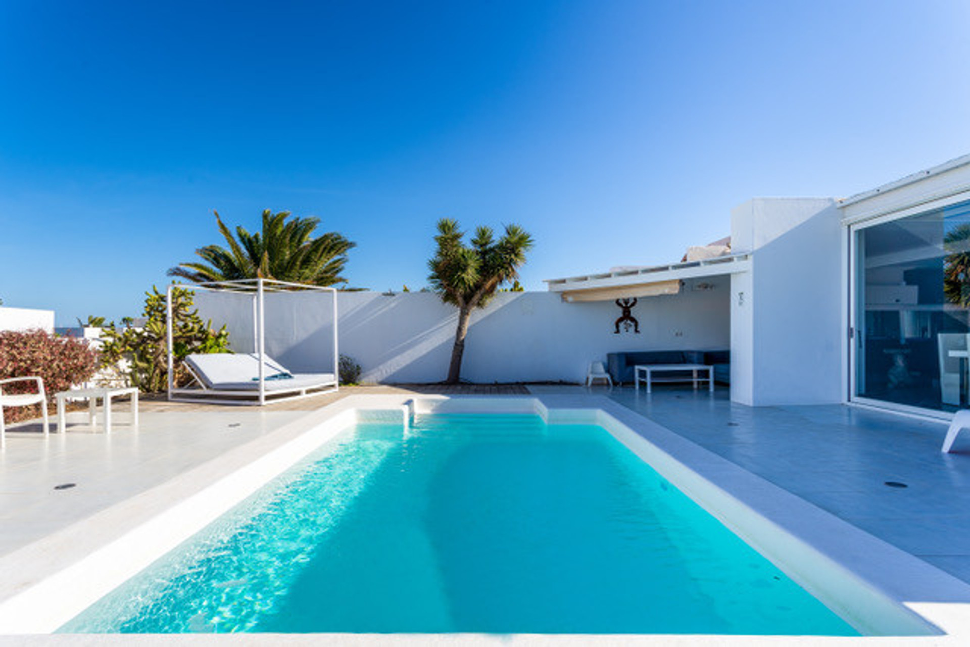 Pool, outside double lounge bed and 4 lying chairs. 