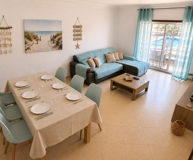 Living room with dining table pool view