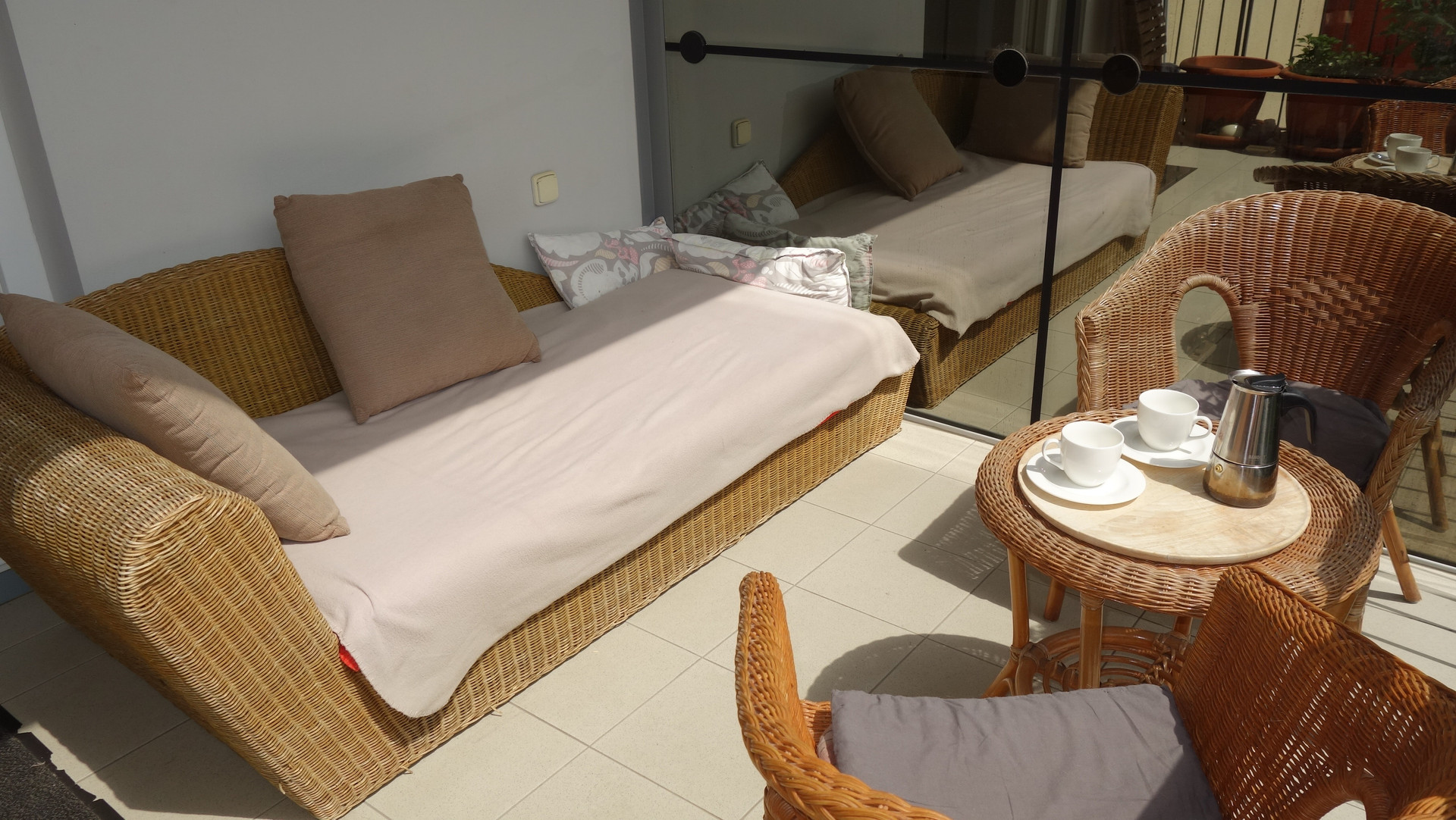 and a rattan sofa.