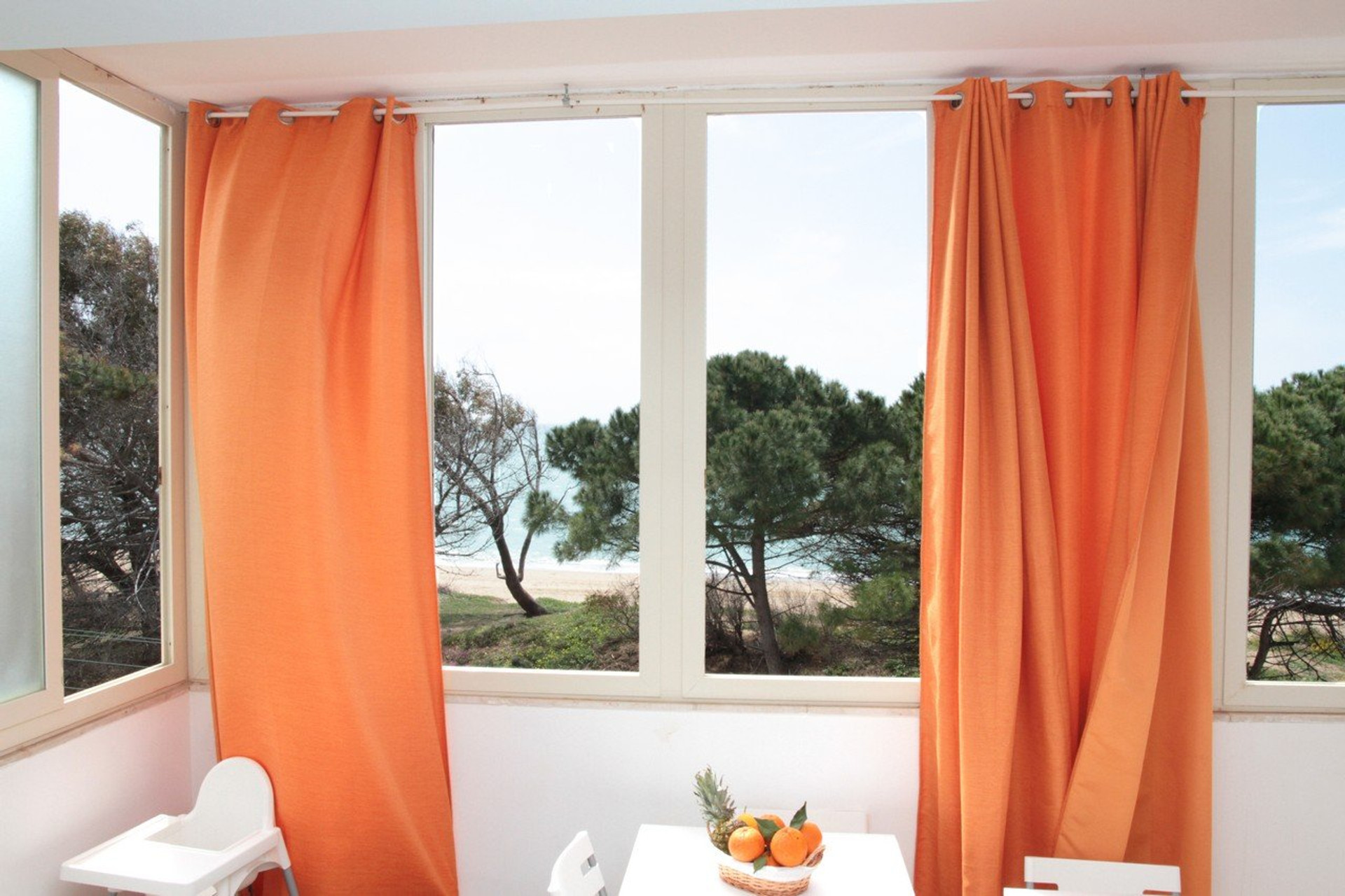 Dining table by windows, beach view