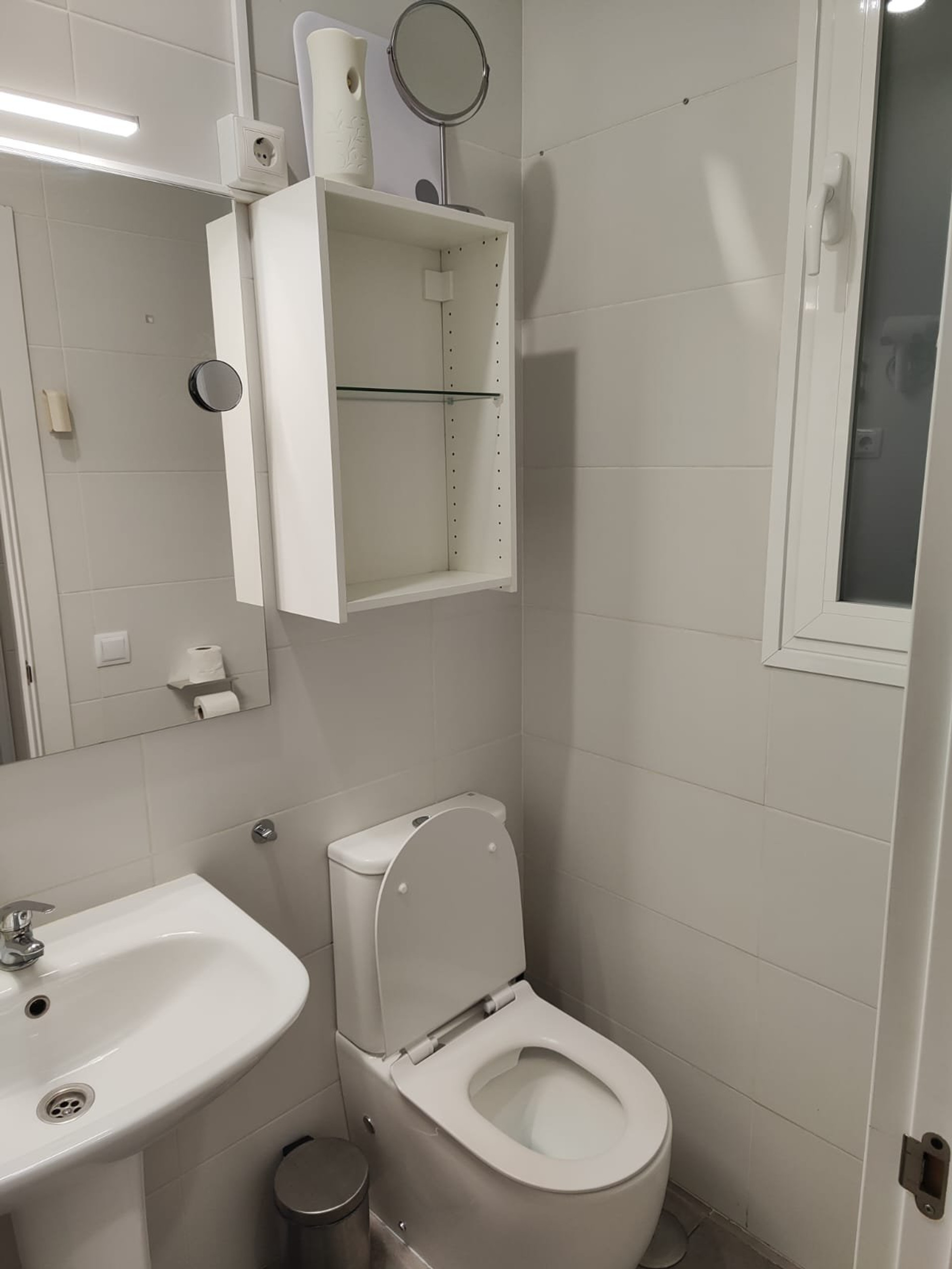 Bathroom with toilet and shelving