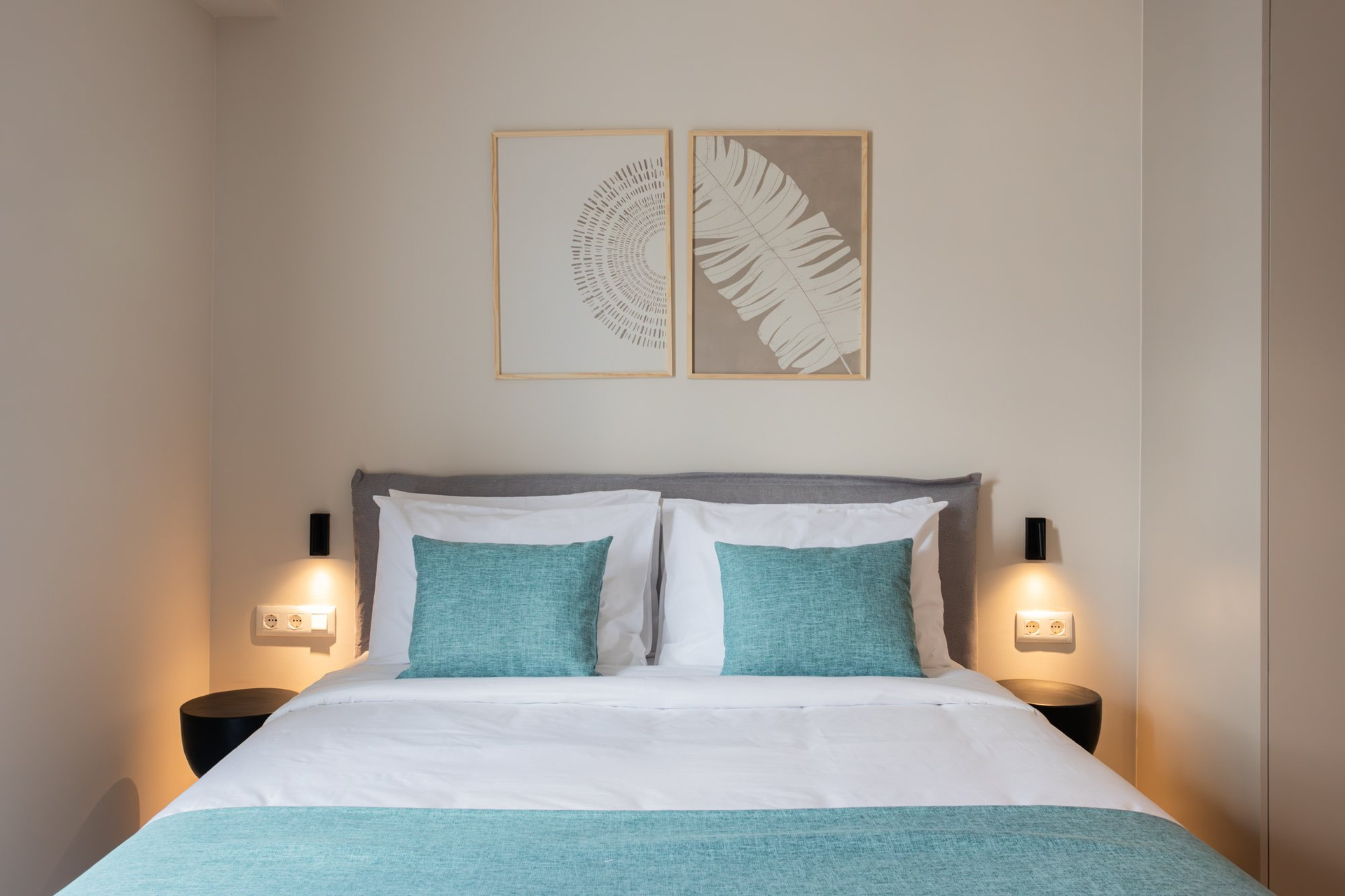 Double bed with teal accent pillows