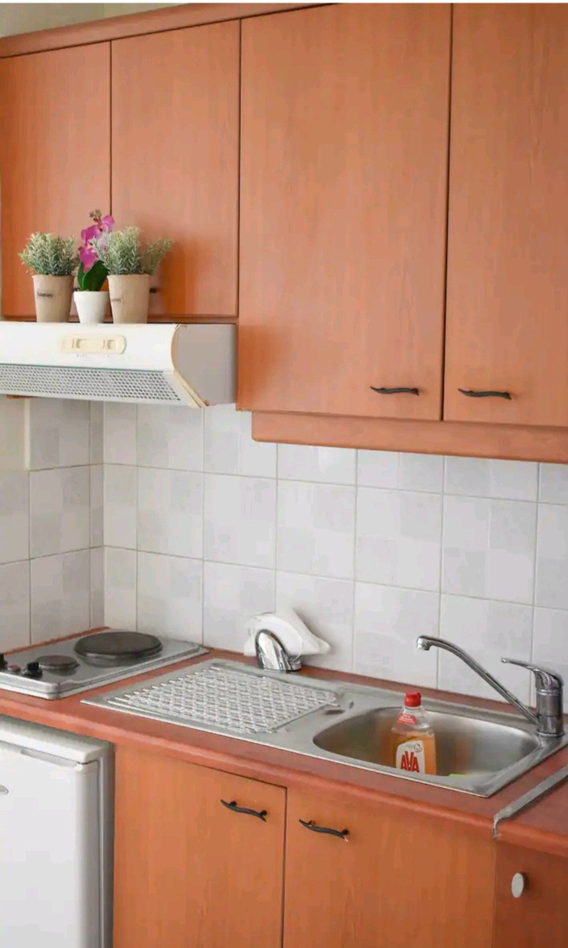 Kitchen with wooden cabinets stovetop