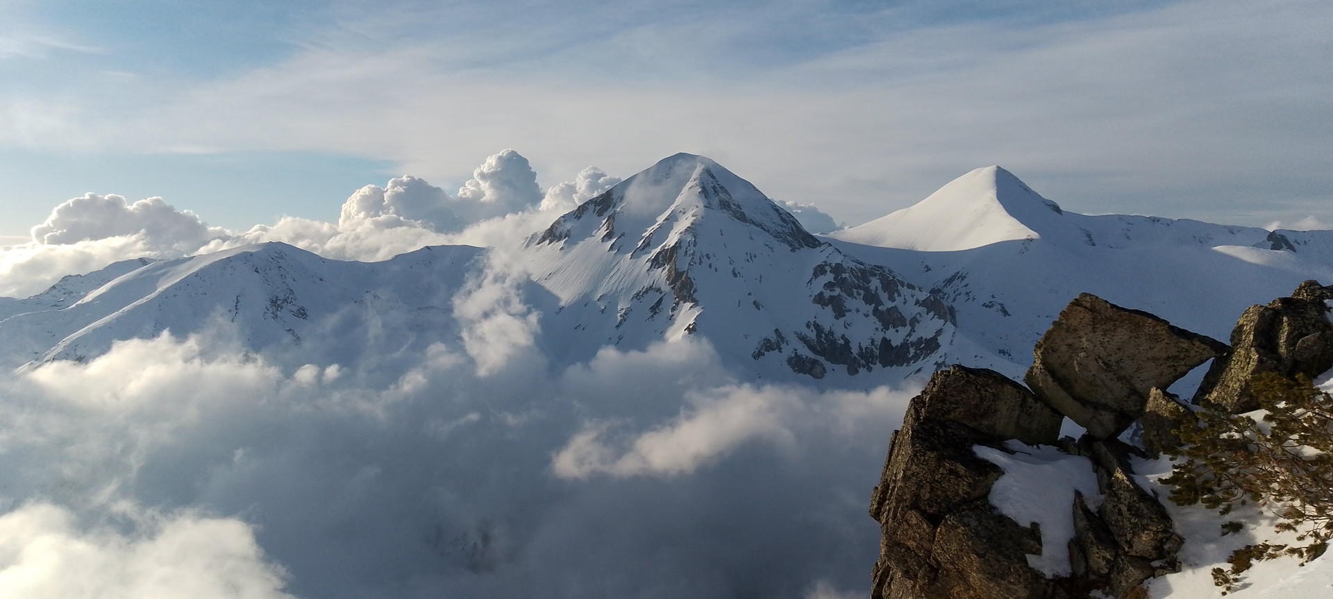Snowy peaks above clouds