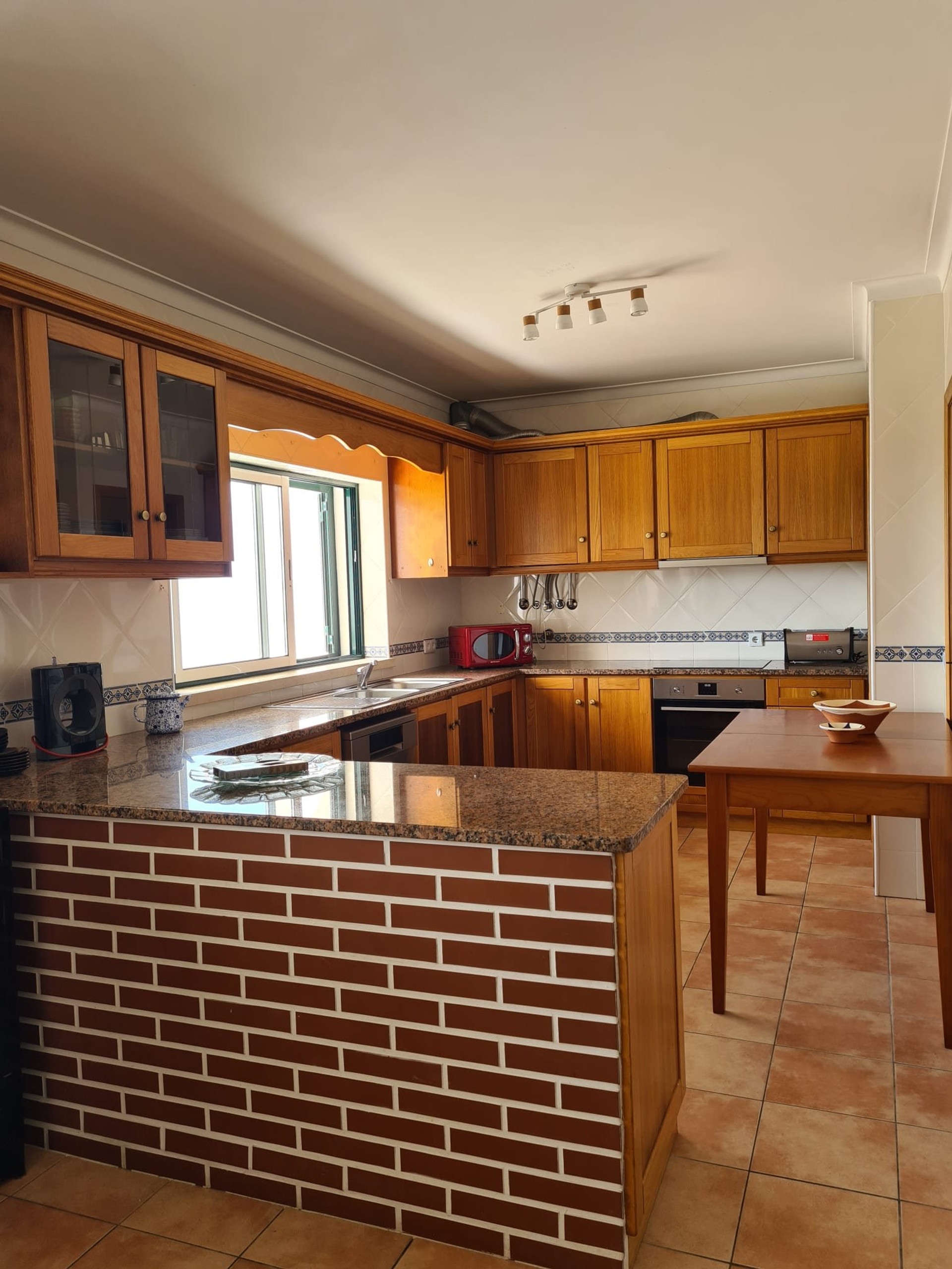 Kitchen with wooden cabinets and island