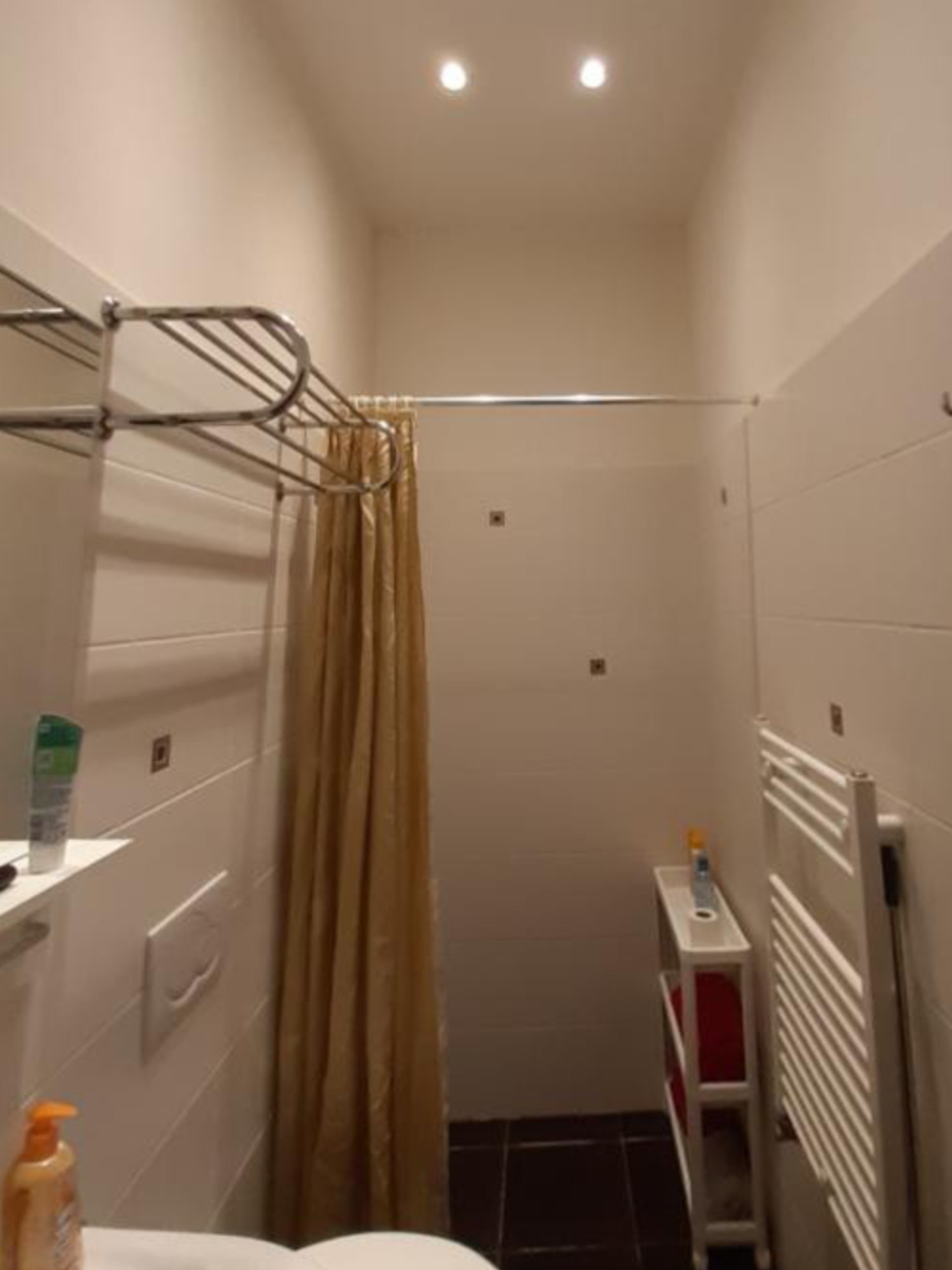 Bathroom with shower and heated towel rail