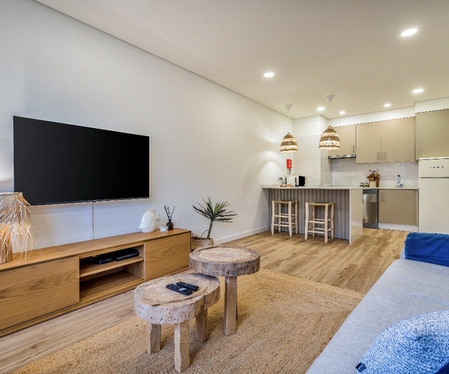 Living room with TV and kitchen