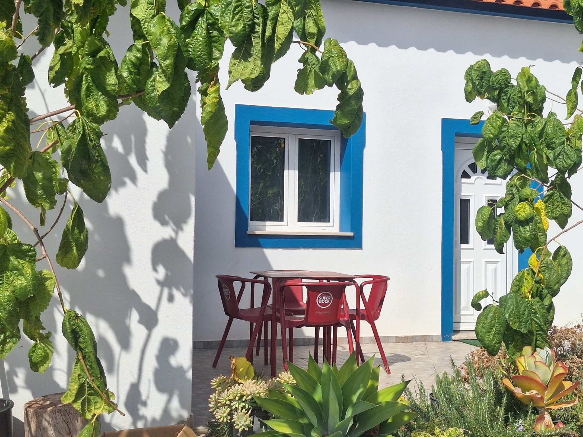 House exterior with red chairs