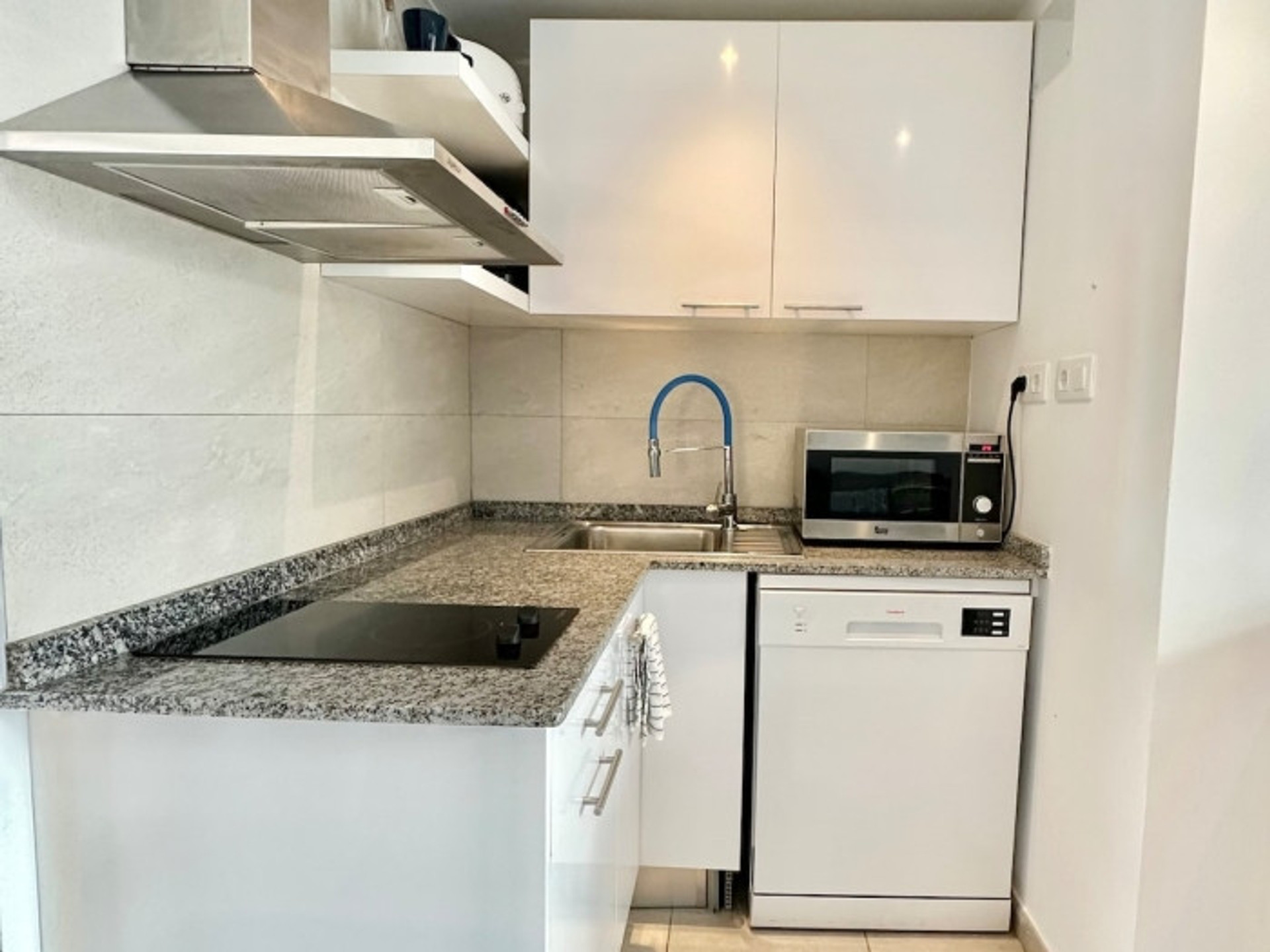 White kitchen with granite countertops