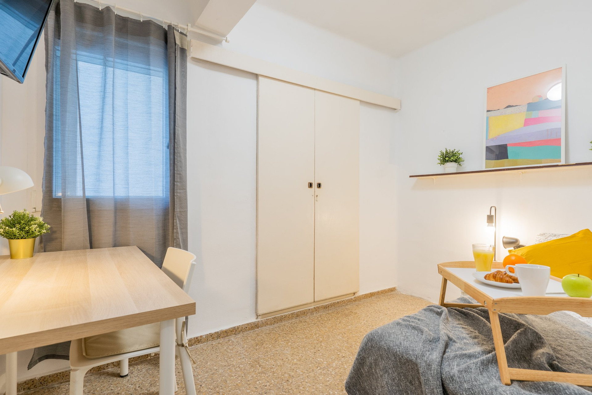 Bedroom with closed wardrobe and bed
