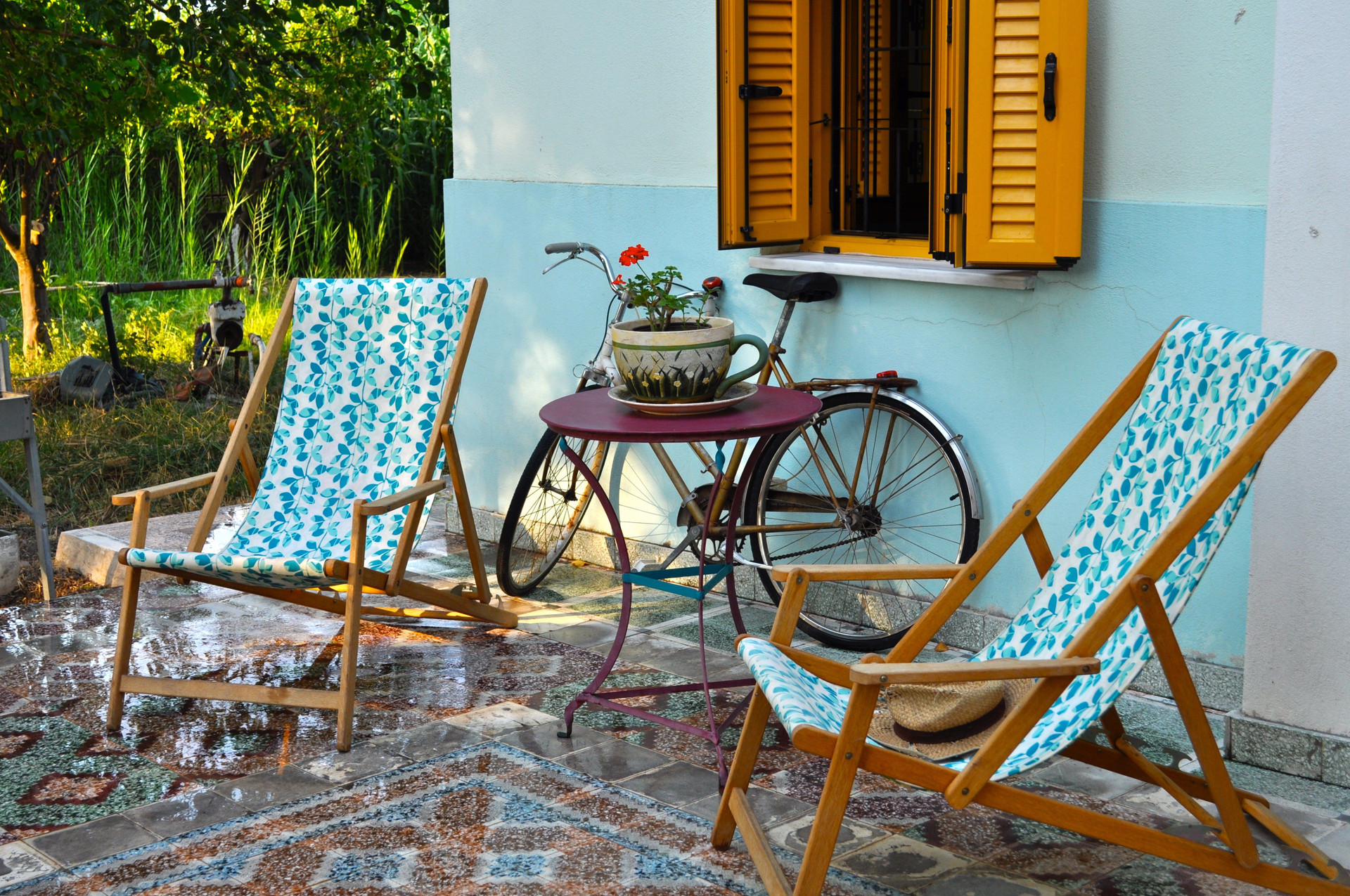 Patio with deck chairs and bike