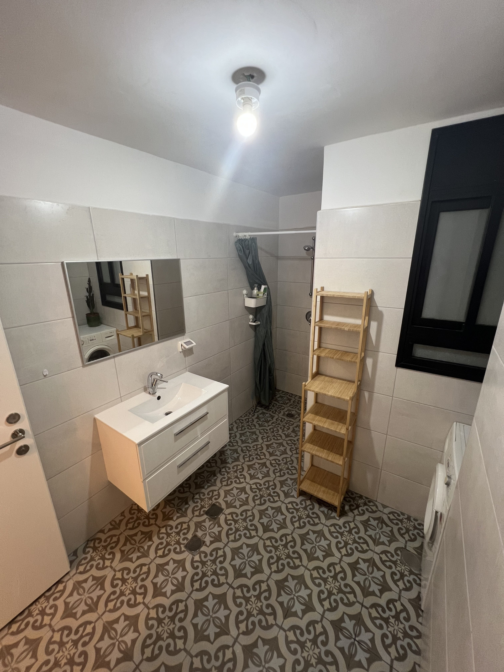 Bathroom with patterned tiles and sink