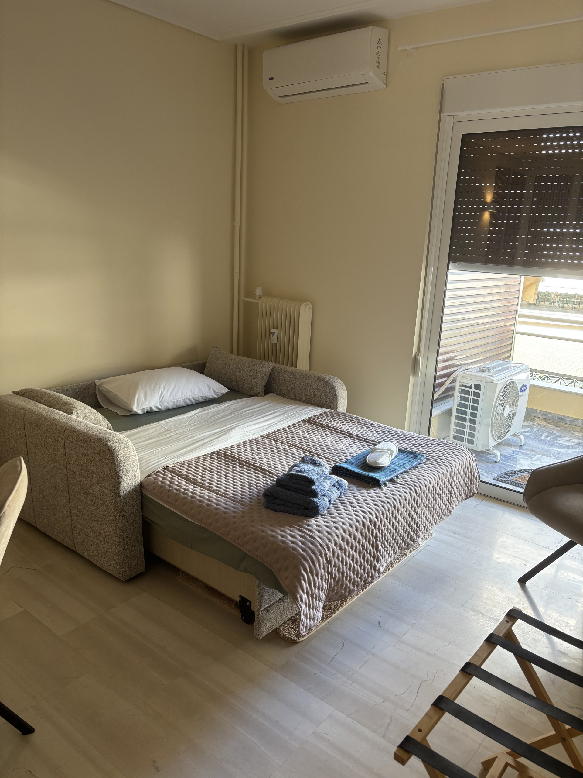 Versatile living space featuring a sofa that easily converts into a comfortable double bed. Equipped with its own air conditioning unit.
