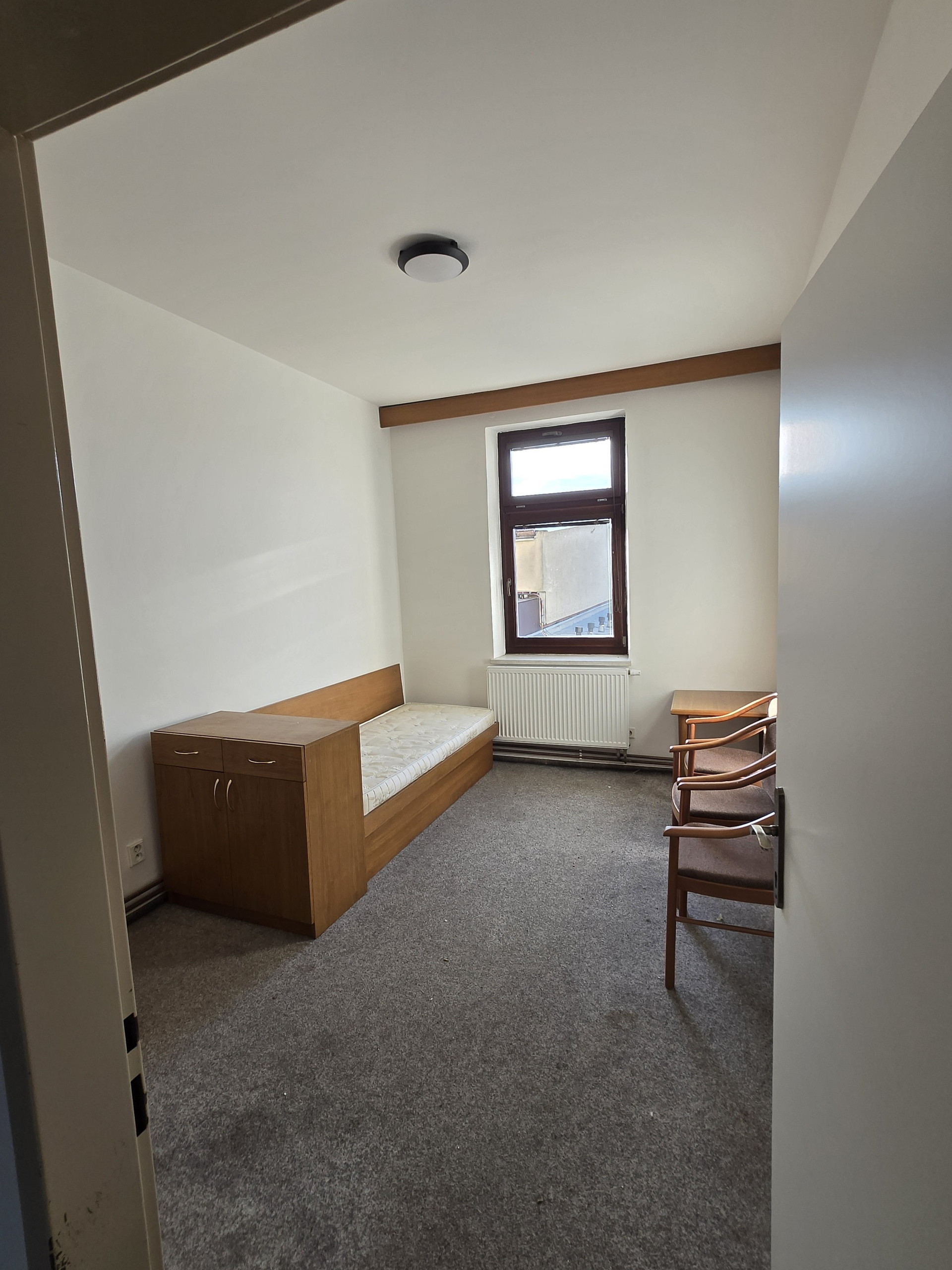 Bedroom with dresser and window