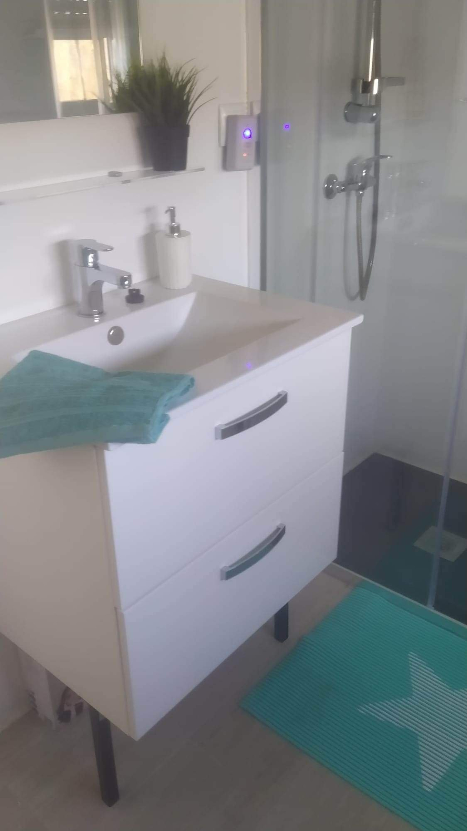 Bright bathroom with sink and shower
