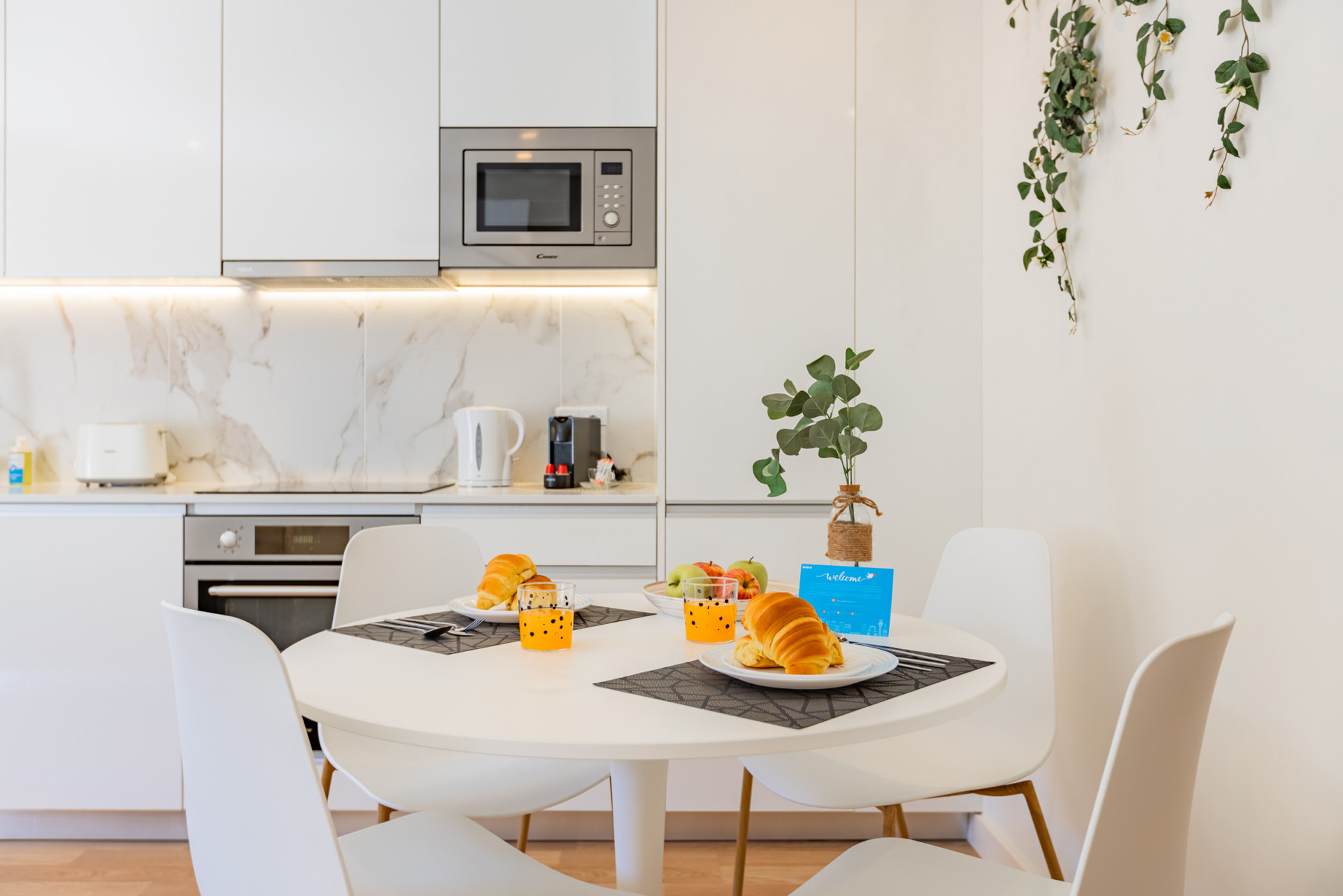 Fully equipped kitchenette with dishwasher and dining table.