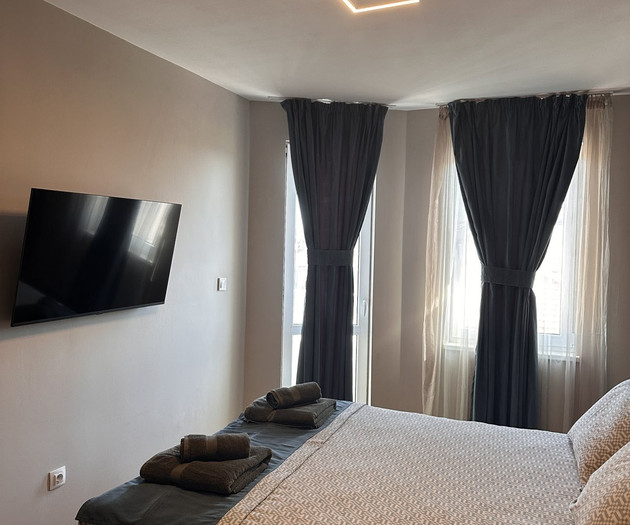 Bedroom with TV and bed