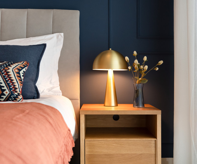 Bedside table with gold lamp