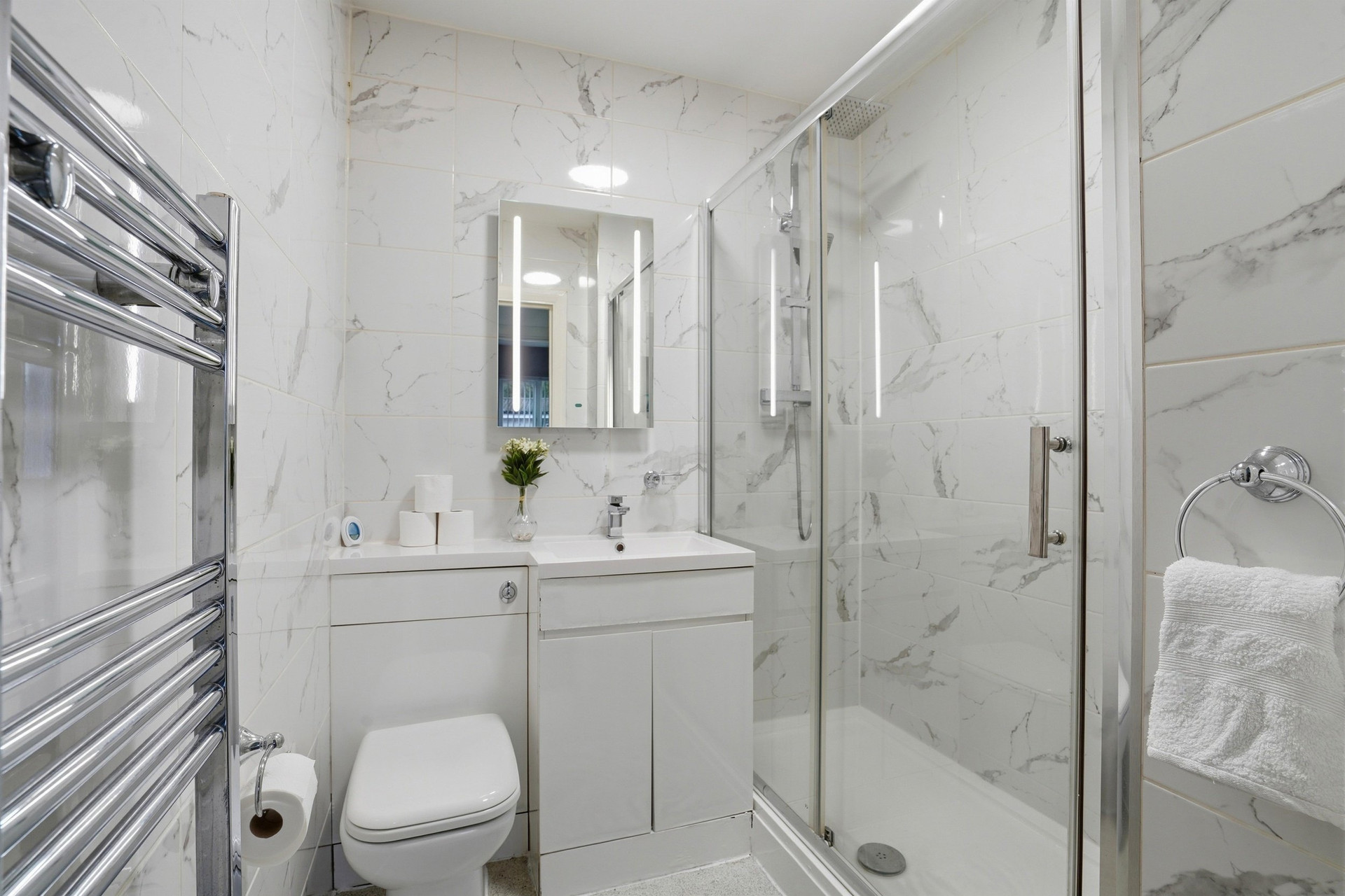 Marble tiled shower room with toilet