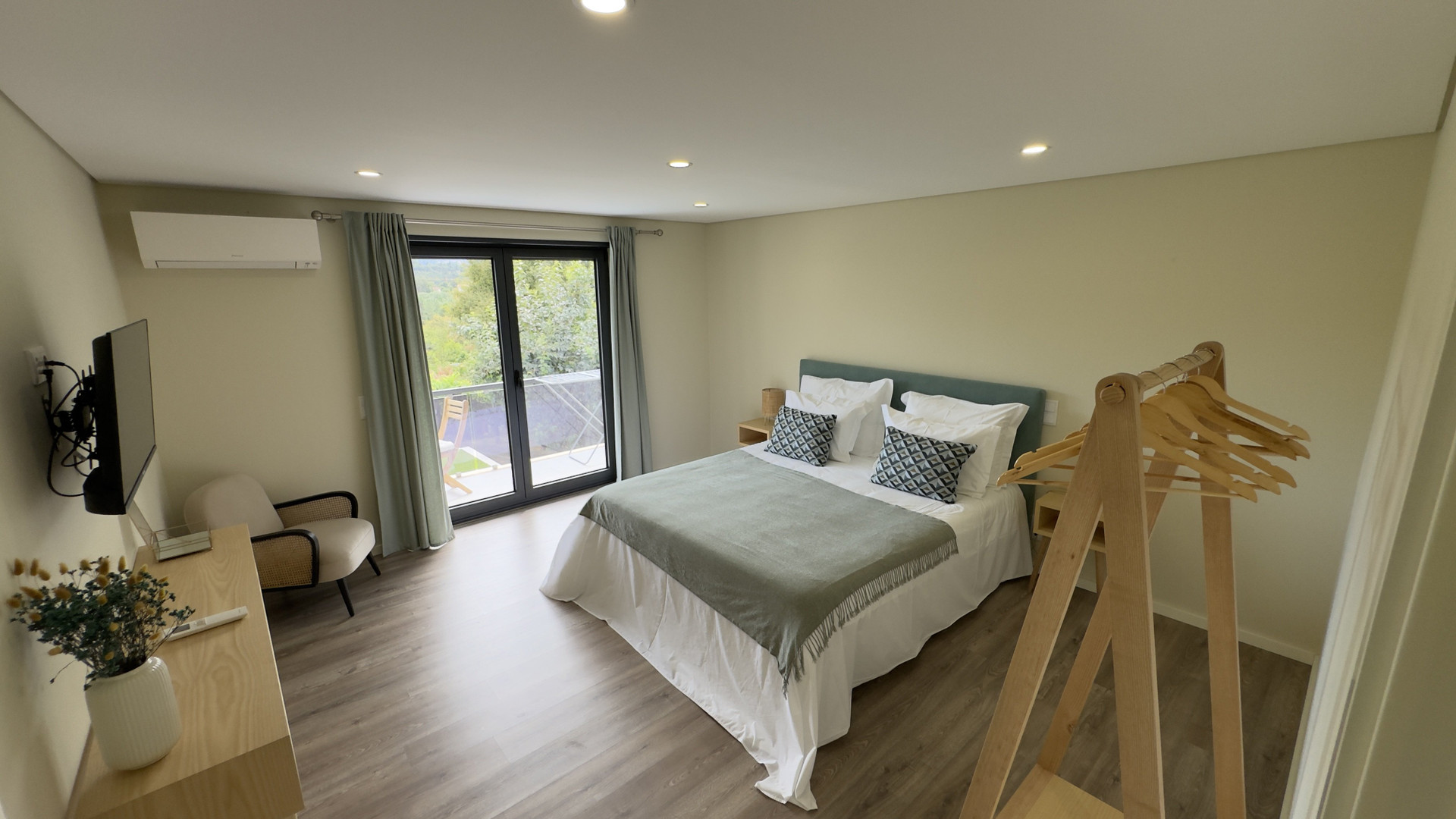 Bedroom with balcony and clothes rack