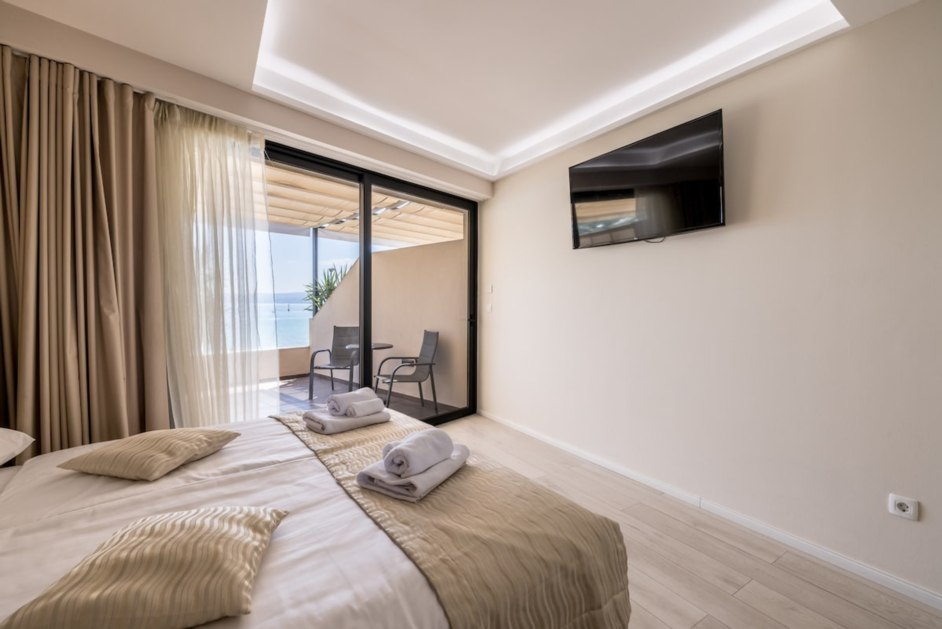 Bed facing a flat-screen TV.