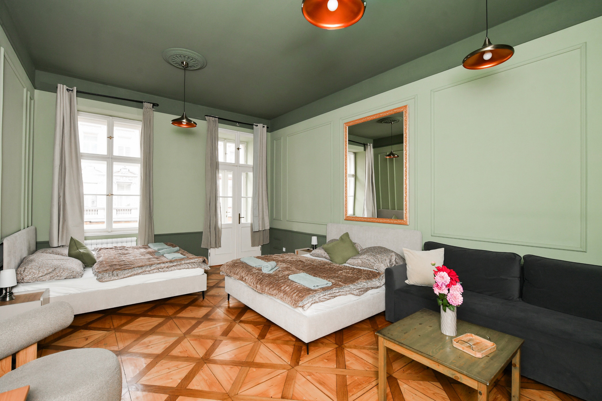 Bright bedroom with beds and sofa
