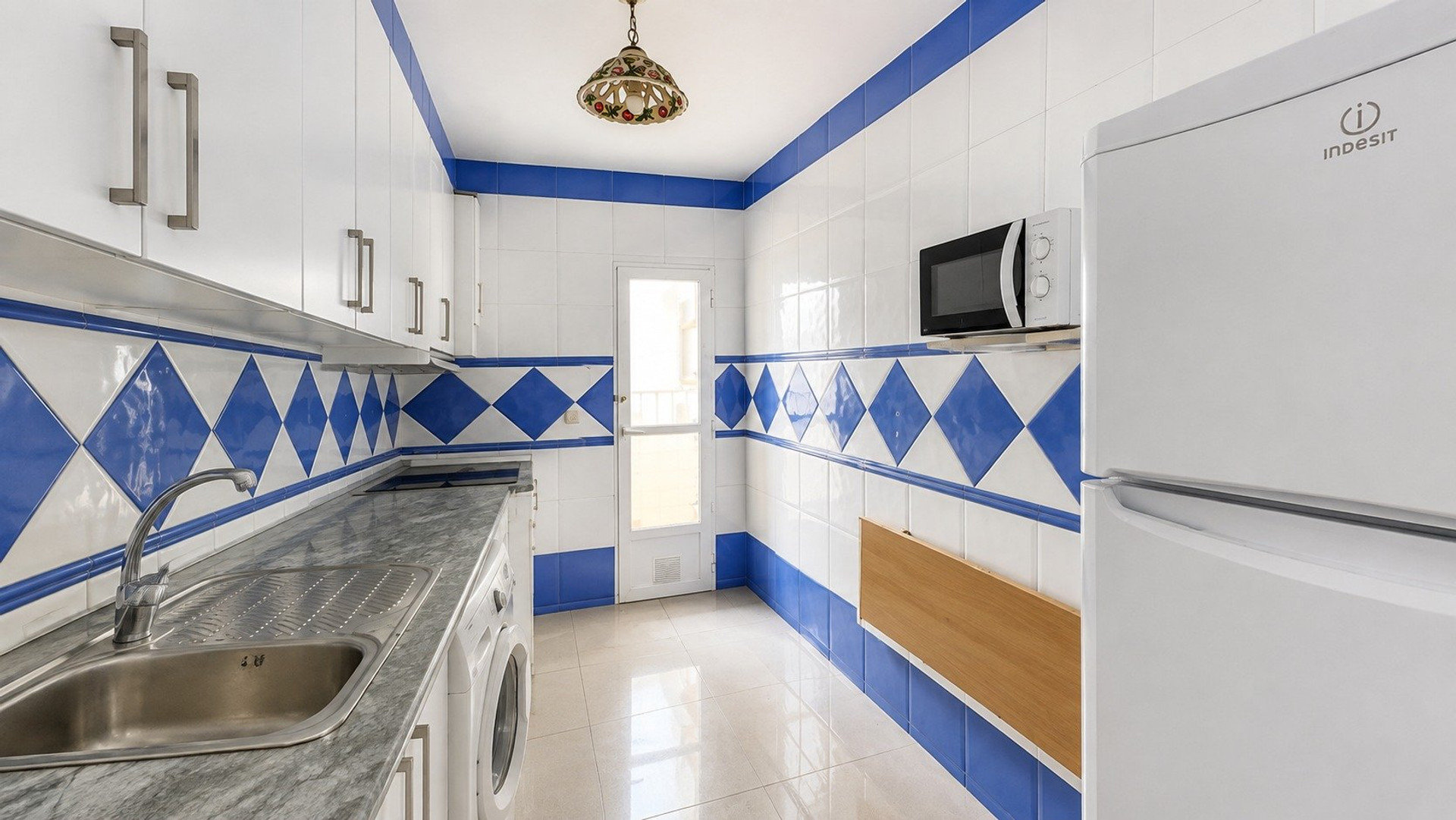 Kitchen with blue tile accents