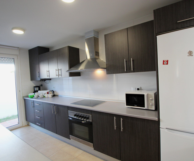 Modern kitchen with oven and fridge
