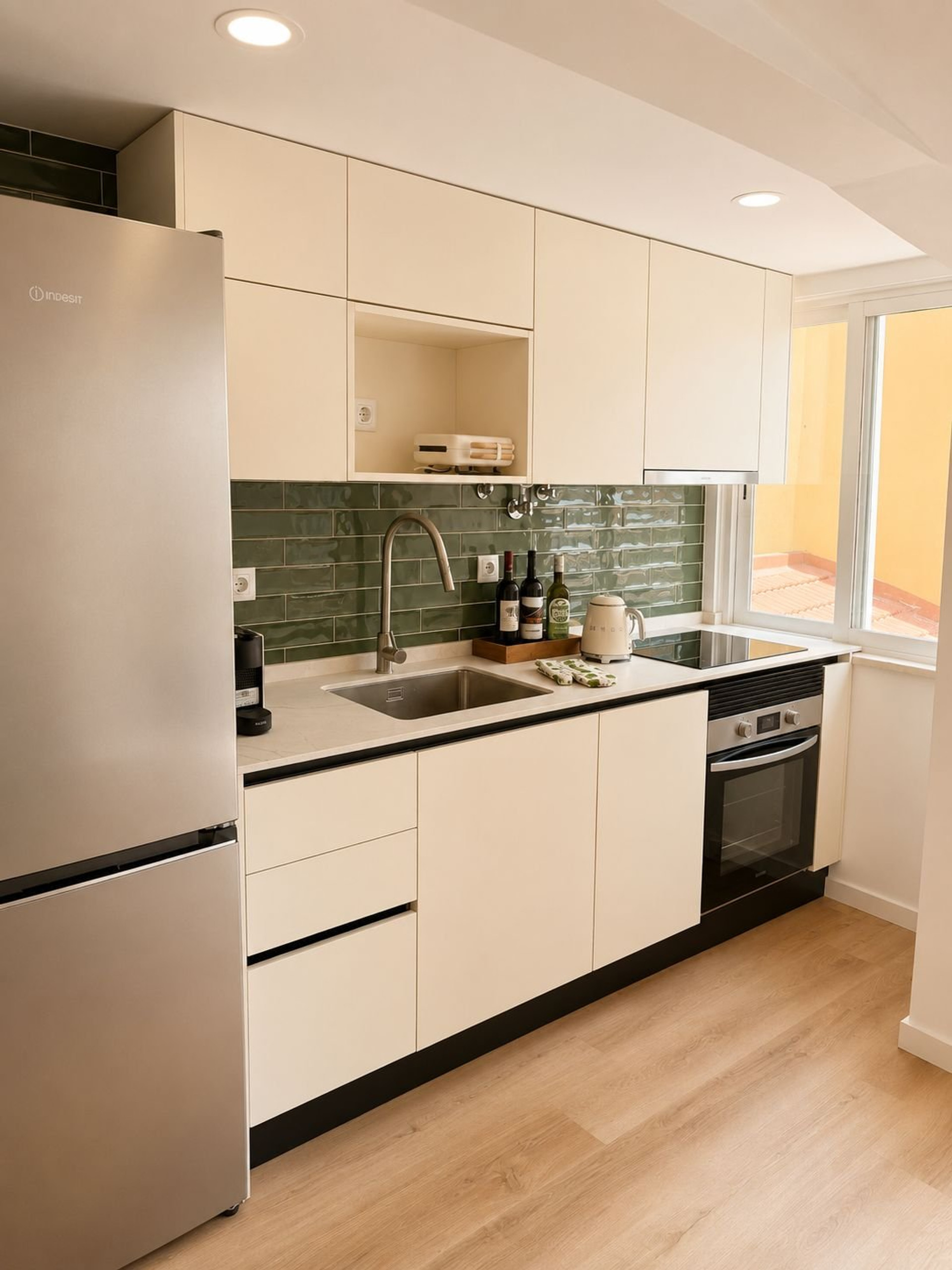 Modern kitchen with green tile backsplash
