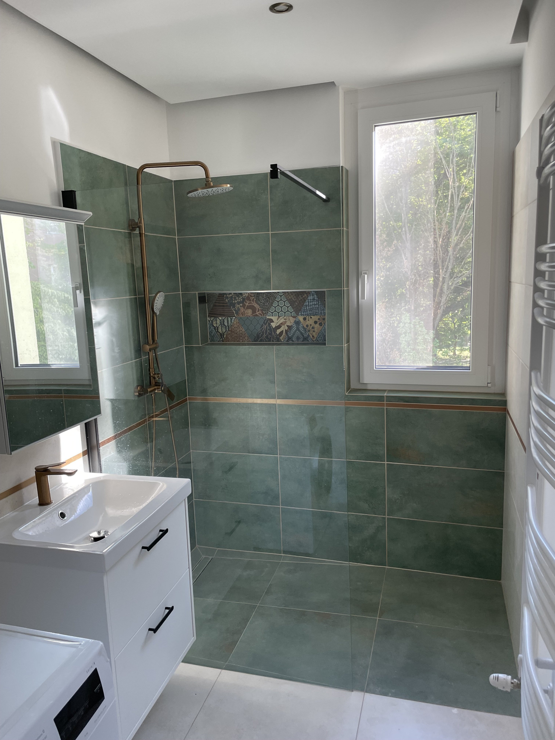 Green tiled shower with window