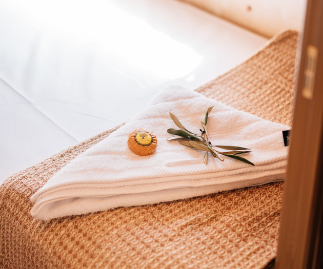 Towel and soap on bed