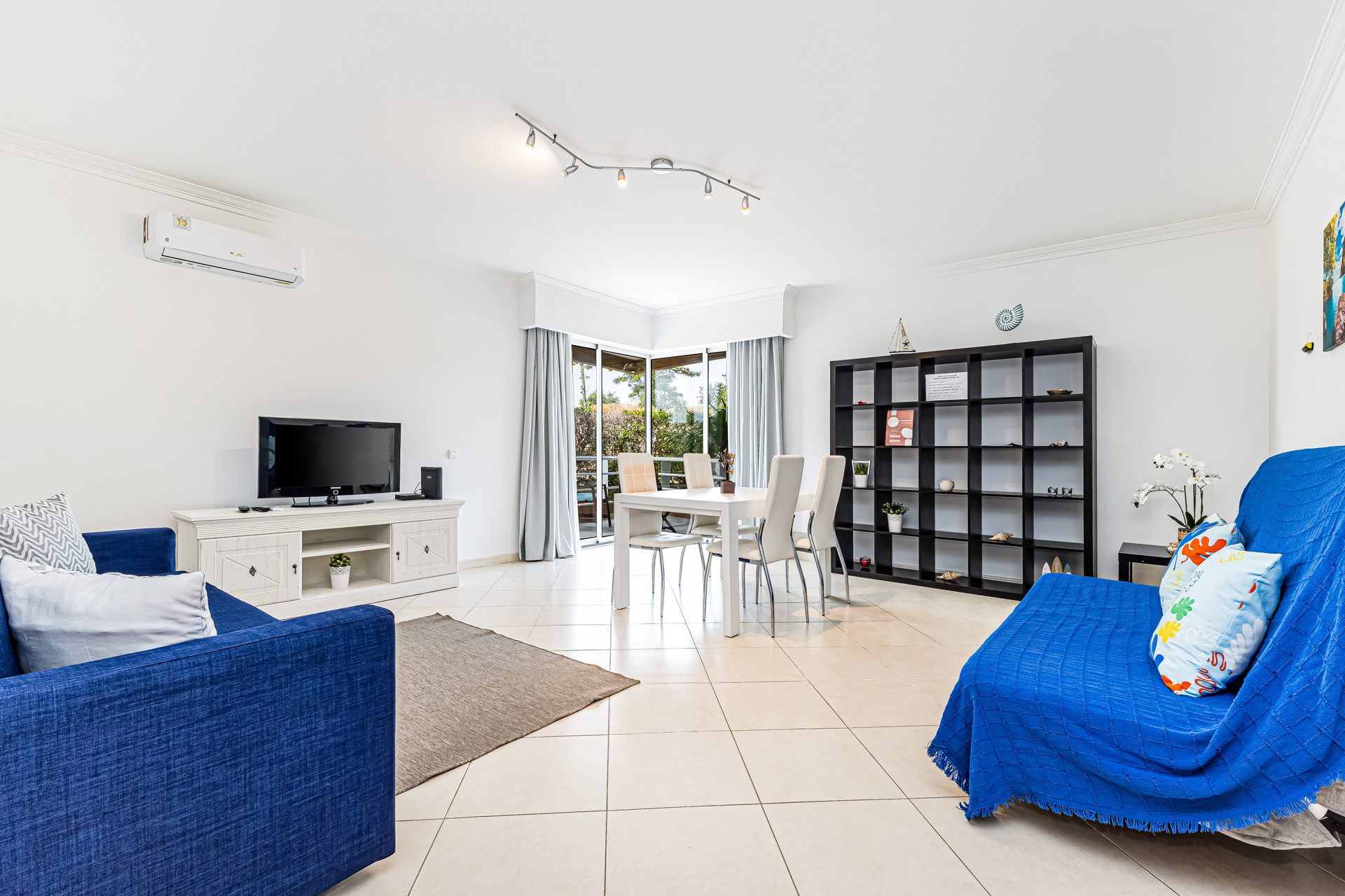 Living room with blue sofas and TV