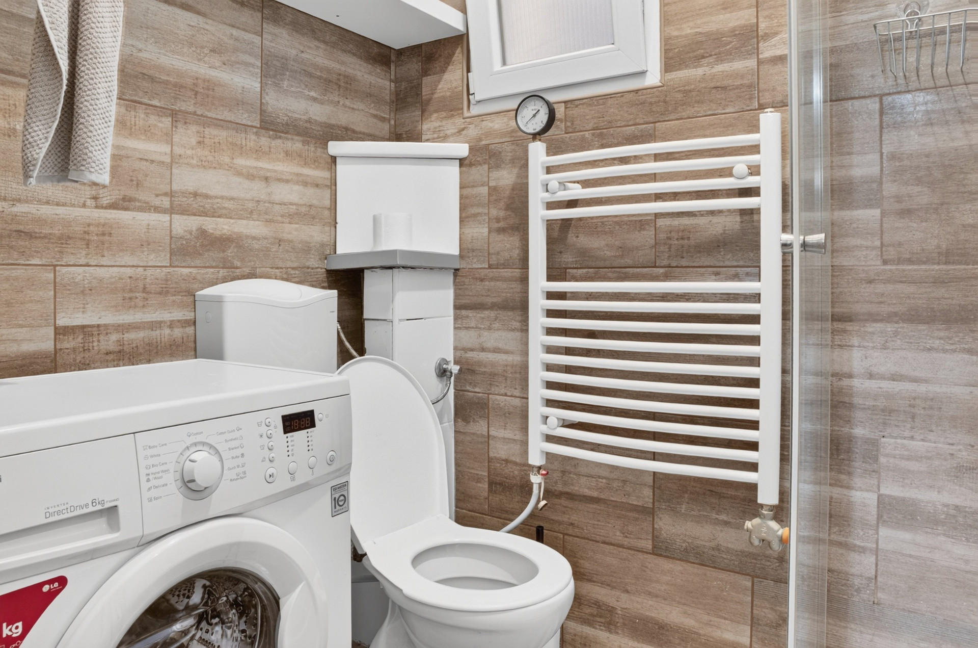 Bathroom with shower toilet washing machine