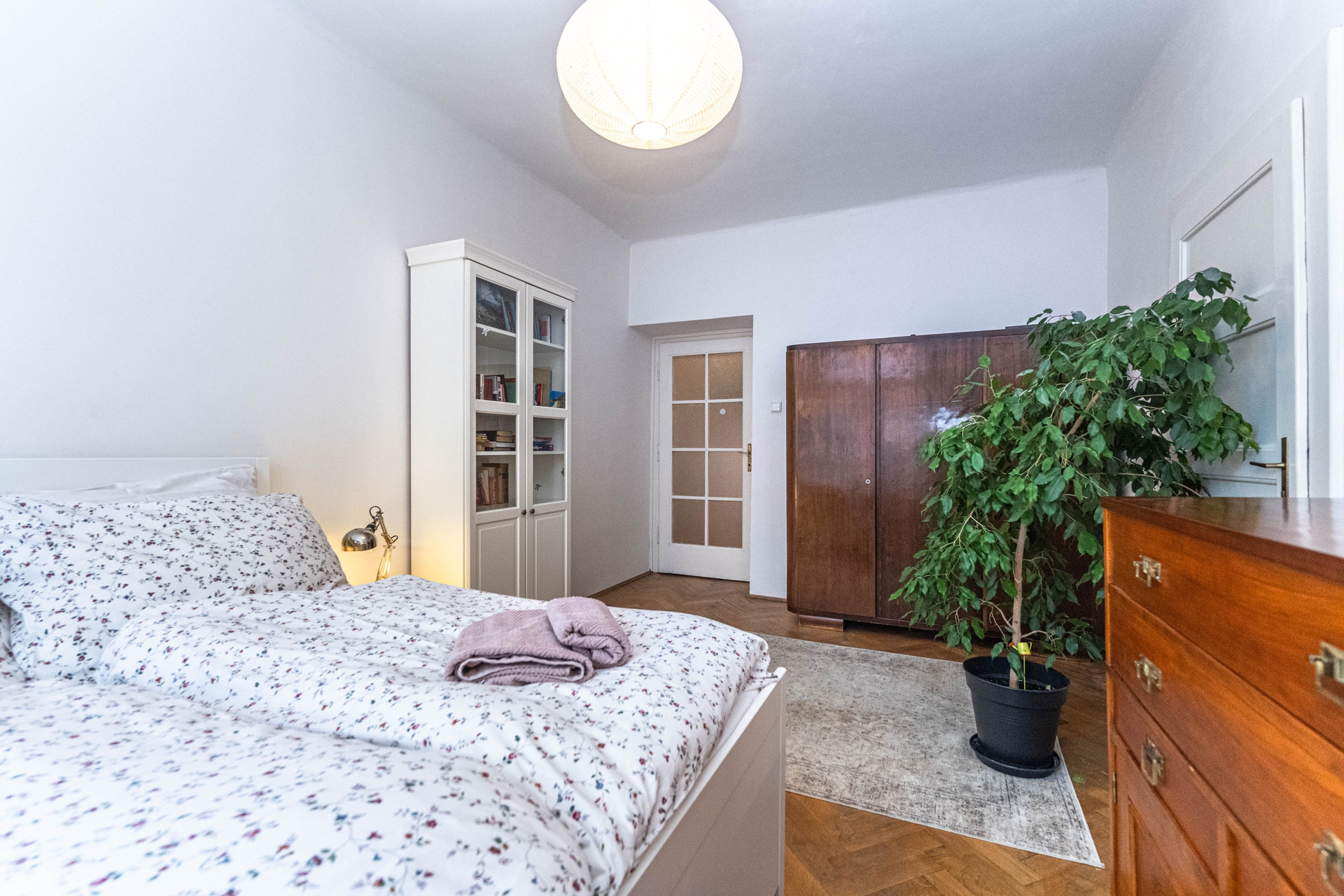 Bedroom with wardrobe and plant