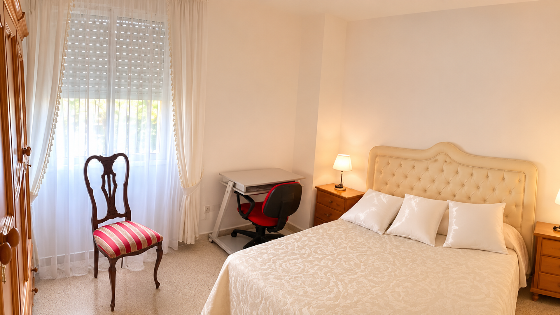 Bedroom with double bed and desk