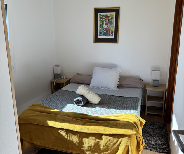 Bedroom with artwork above bed